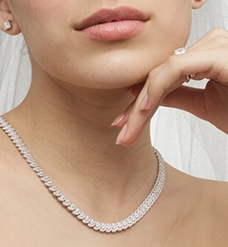 A diamond necklace and matching stud earrings worn for a special occasion
