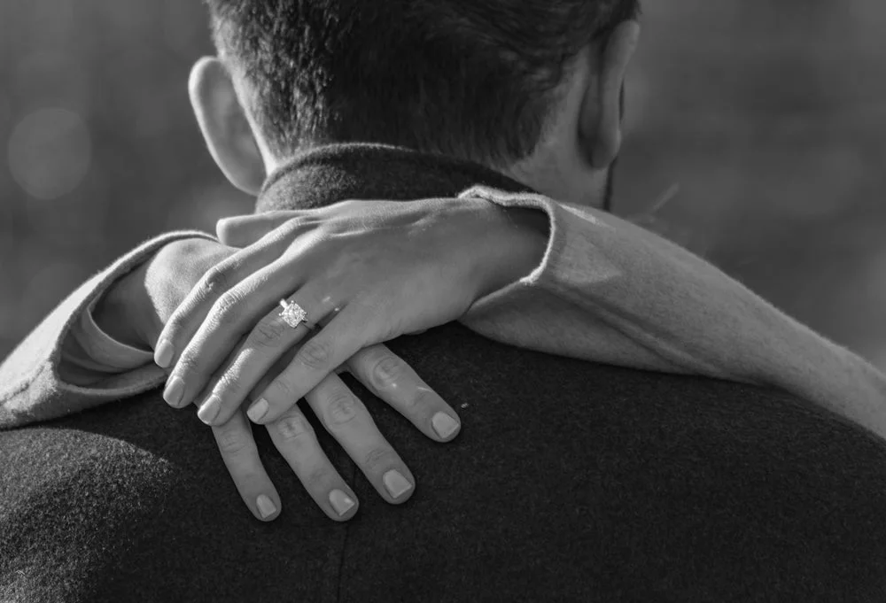 A couple sharing a meaningful moment with an engagement ring